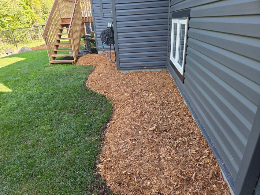 Mulch installation along house